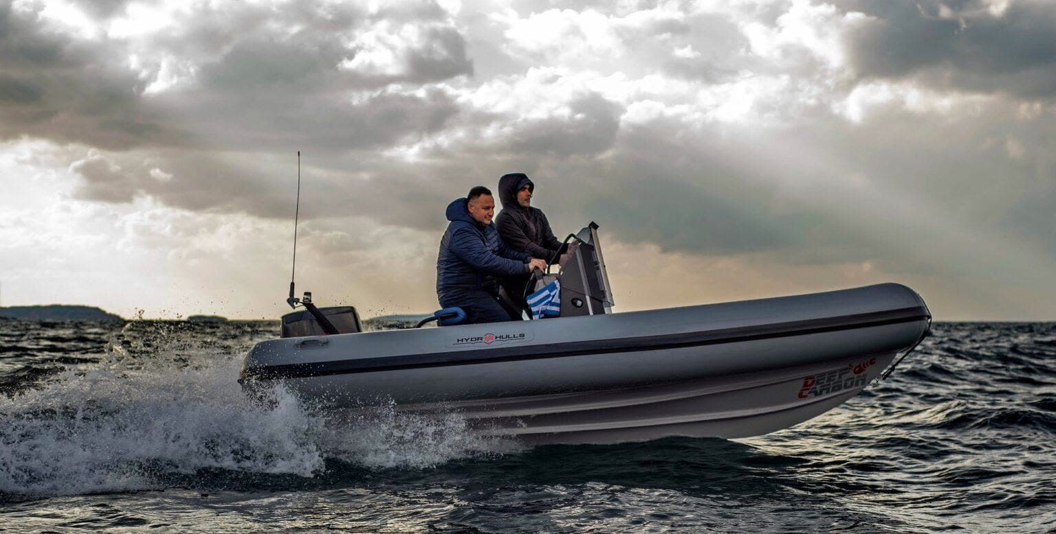 Grey Hydrohulls RIB with Deep Carbon branding at speed