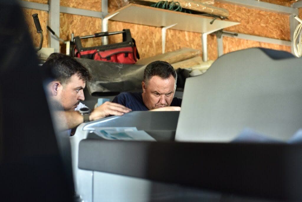 Hydrohulls craftsmen inspecting a hull in the Athens yard